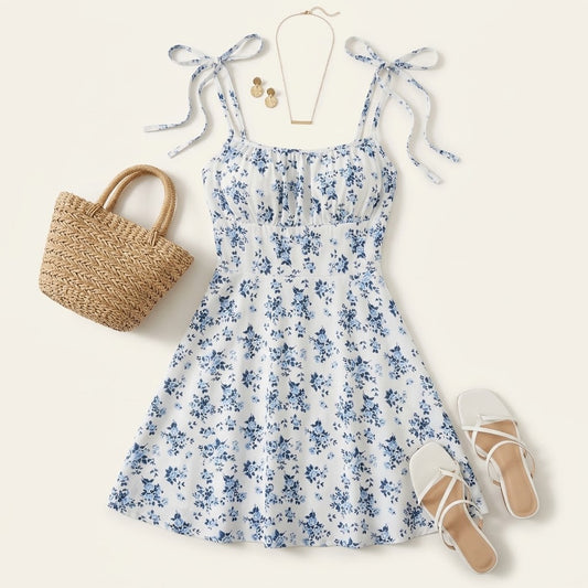 Woman wearing Drapelia floral A-line mini dress with backless detail