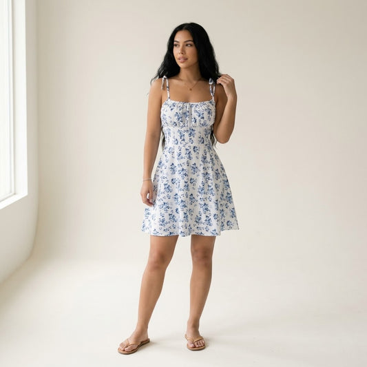 Woman wearing Drapelia floral A-line mini dress with backless detail