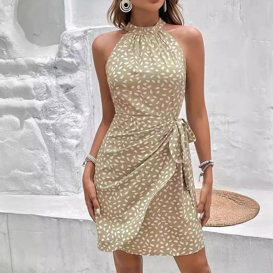 Woman wearing Drapelia floral halter tie-waist dress in a summer print