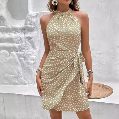 Woman wearing Drapelia floral halter tie-waist dress in a summer print