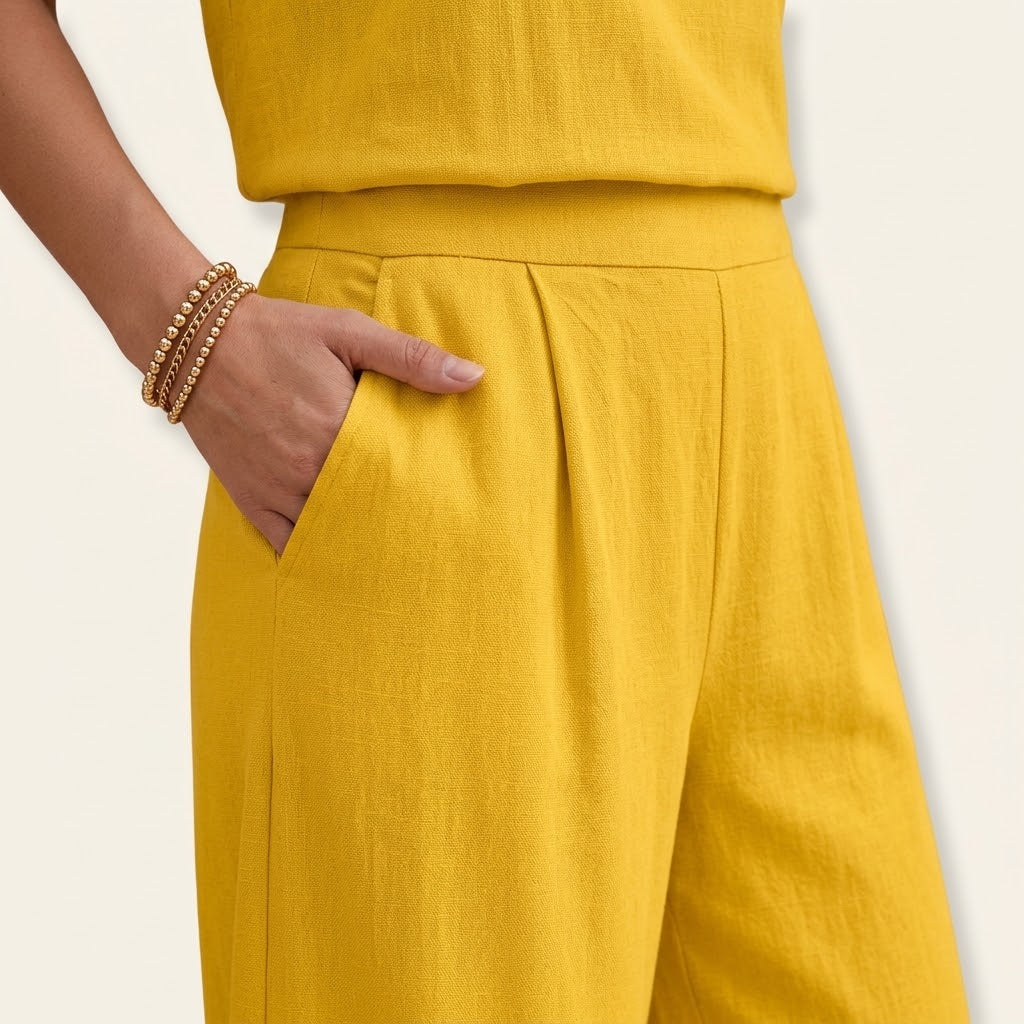 Woman wearing Drapelia sleeveless top and wide pants set in a solid color