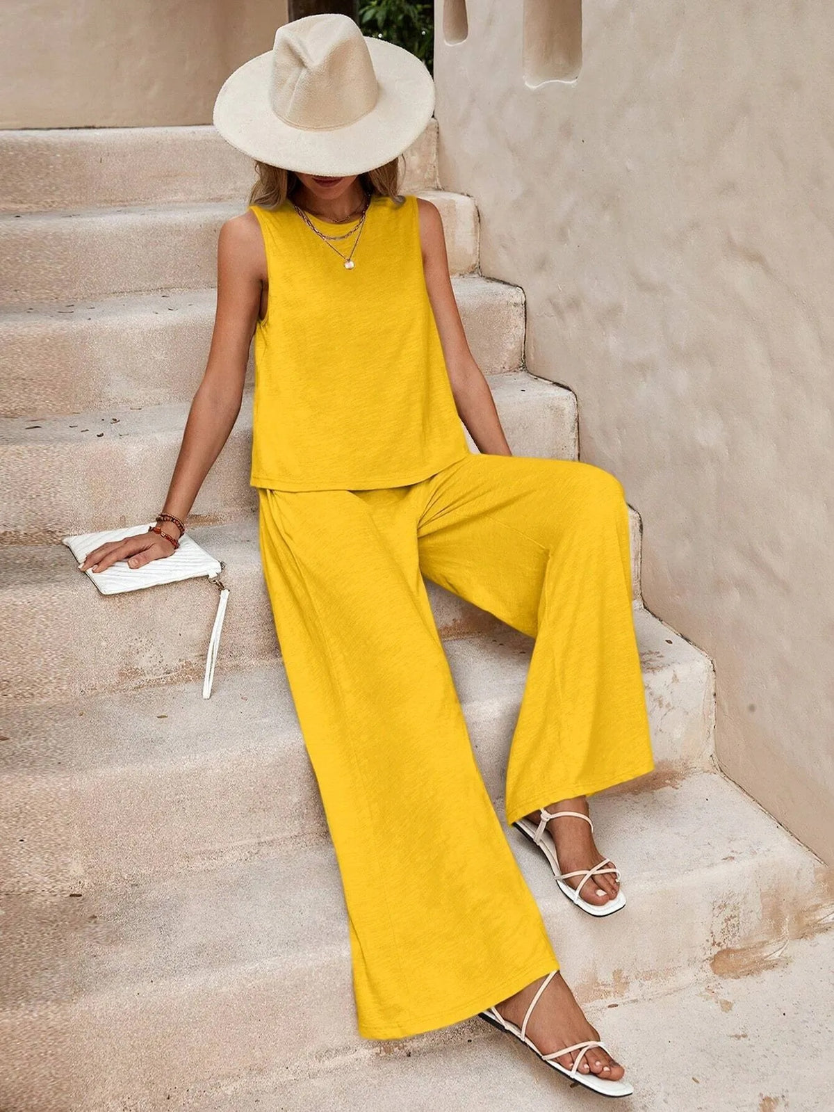 Woman wearing Drapelia sleeveless top and wide pants set in a solid color