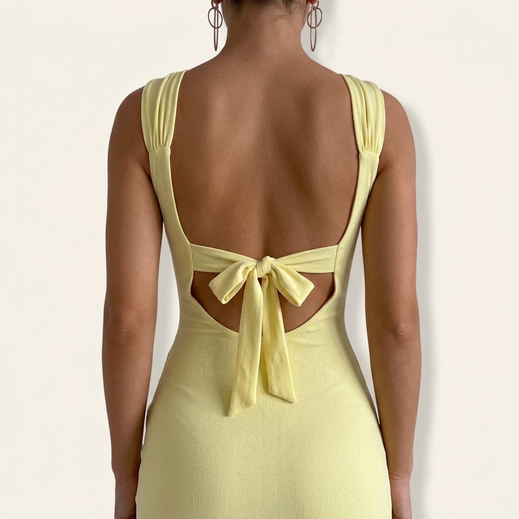 Woman wearing Drapelia slim sleeveless backless slit dress with back tie