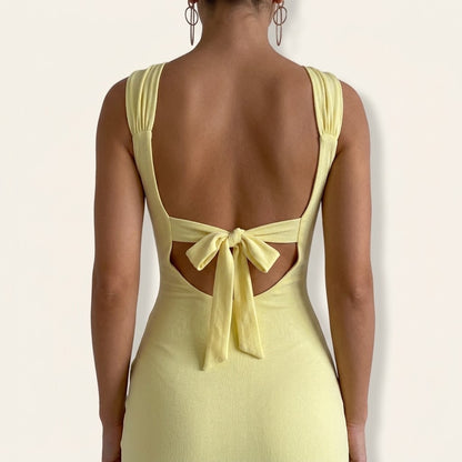 Woman wearing Drapelia slim sleeveless backless slit dress with back tie