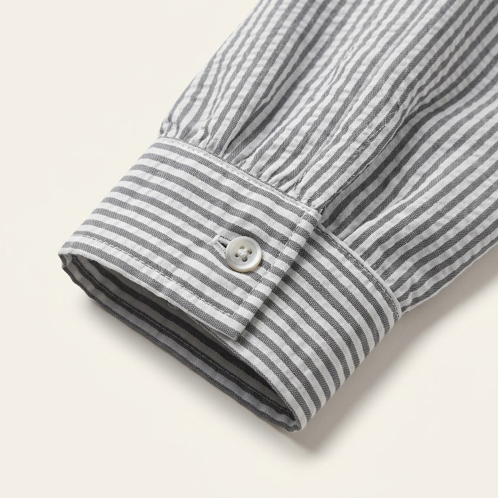 Woman wearing Drapelia striped ruffle button-up blouse with long sleeves