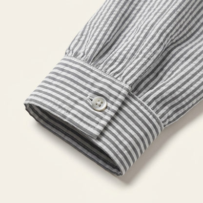 Woman wearing Drapelia striped ruffle button-up blouse with long sleeves